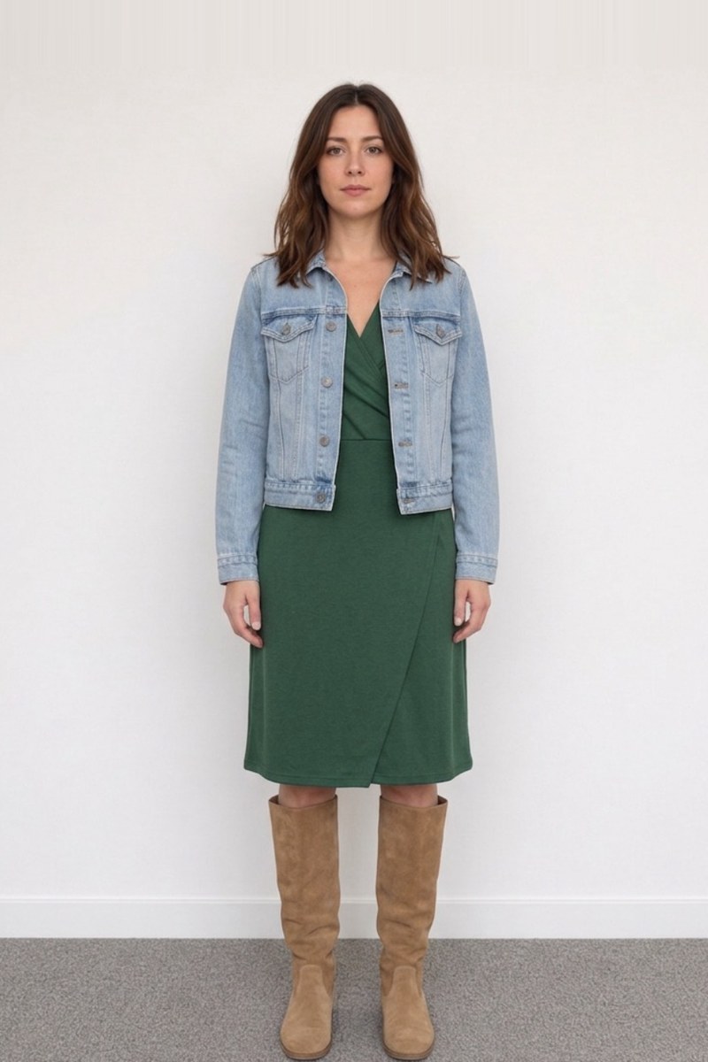 A green wrap dress with a denim jacket and tan boots